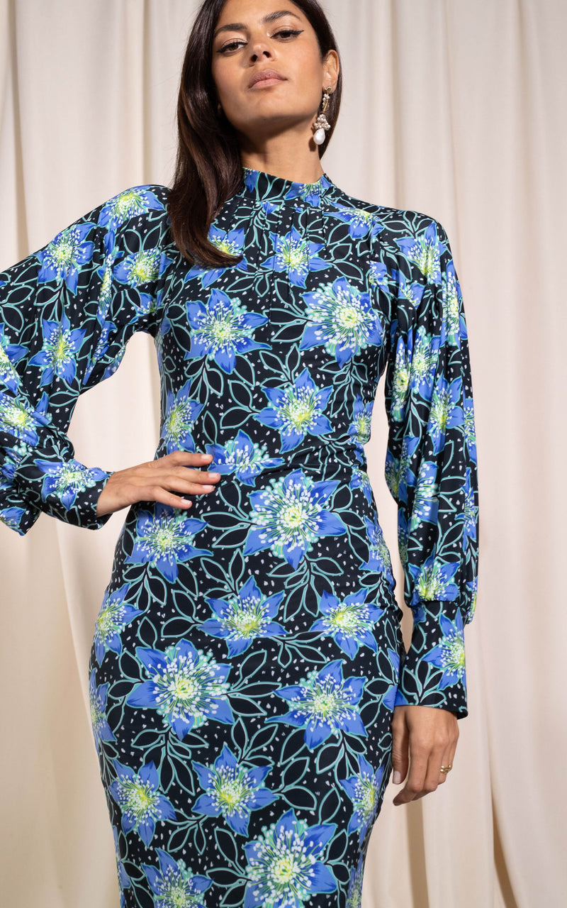 Close up of Dancing Leopard model standing with hand on hip wearing Zoe midi dress in rata blue 