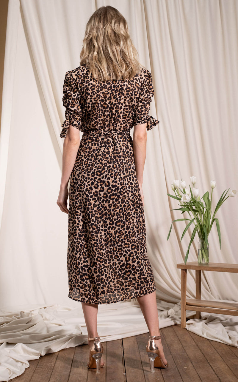 Dancing Leopard model standing with back to the camera wearing Olivera midid dress in rich leopard