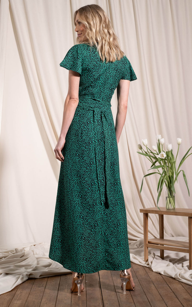 Dancing Leopard model standing back to the camera wearing Cayenne dress in small green leopard