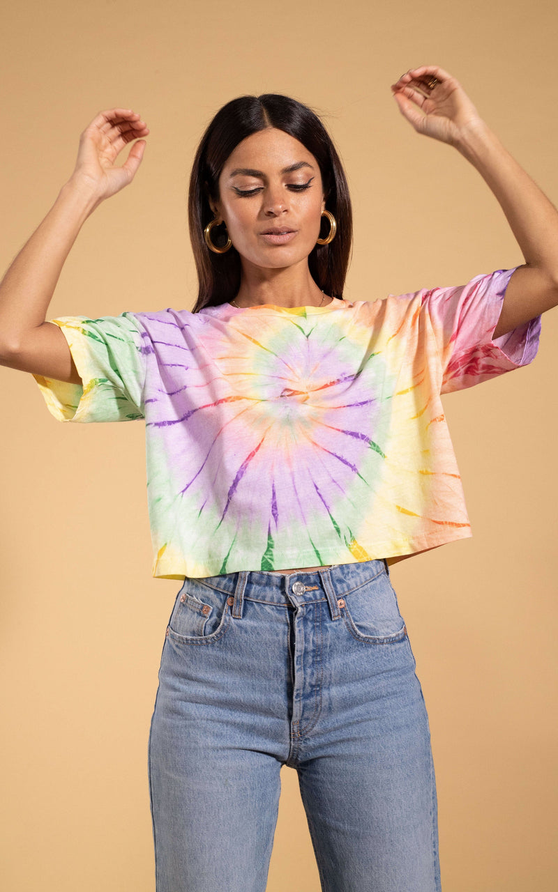 Dancing Leopard model standing with hands in the air wearing Happy hippie cats charity t-shirt with lightwash jeans