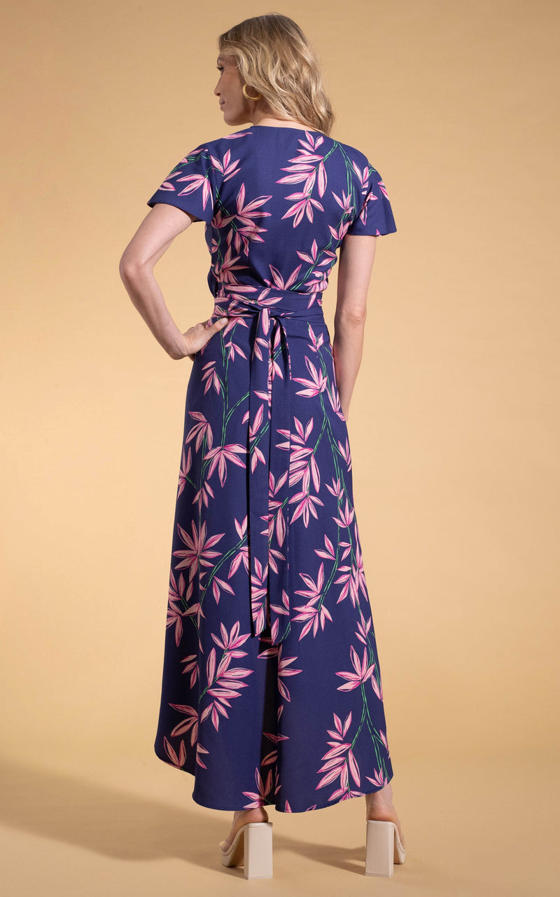 Dancing Leopard model standing backwards  wearing Cayenne midi wrap dress in bamboo navy base with clear heels 