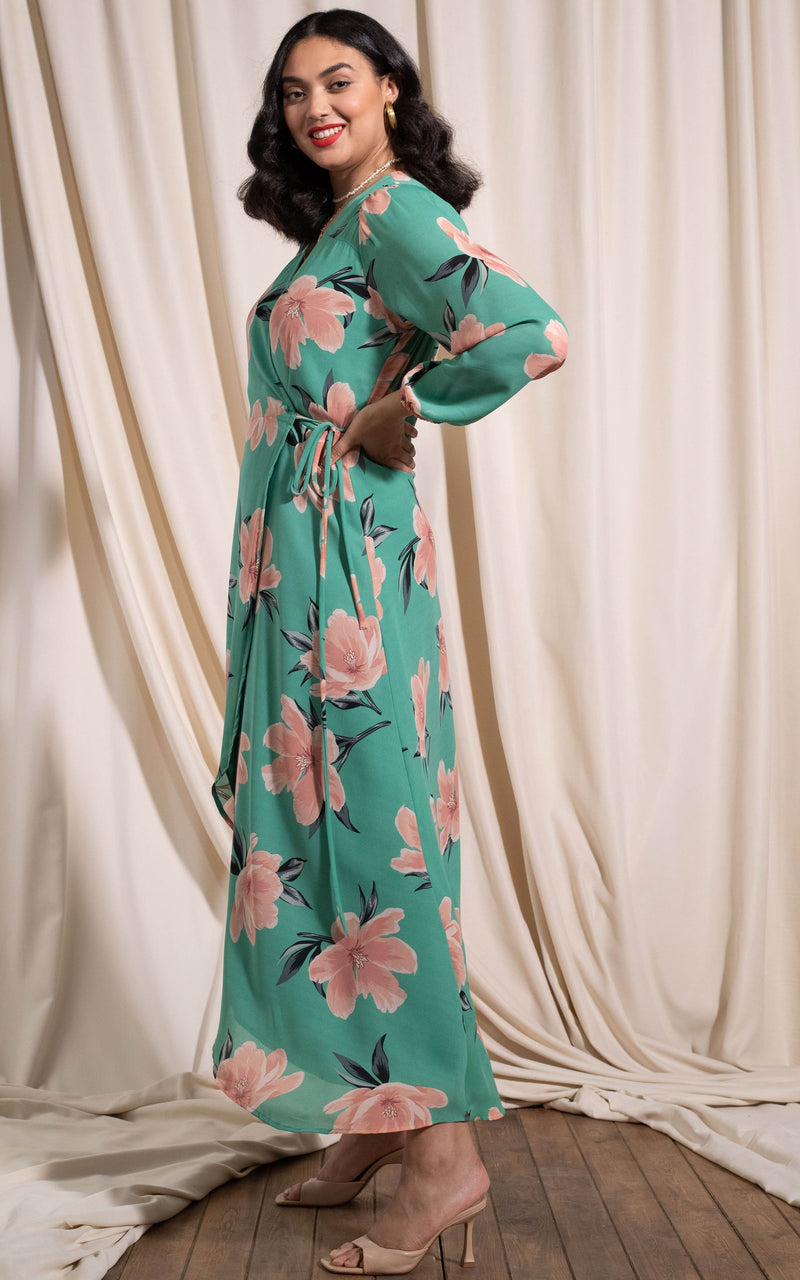 Dancing Leopard model standing sideways looking ar camera wearing jagger dress in sage base tulip