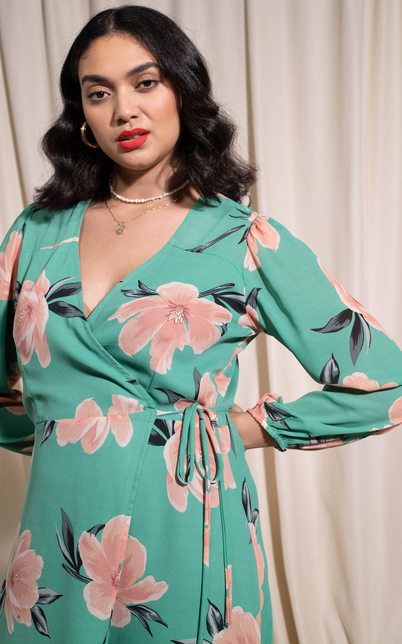 Close up of Dancing Leopard model with hand on hip wearing Jagger dress in sage base tulip