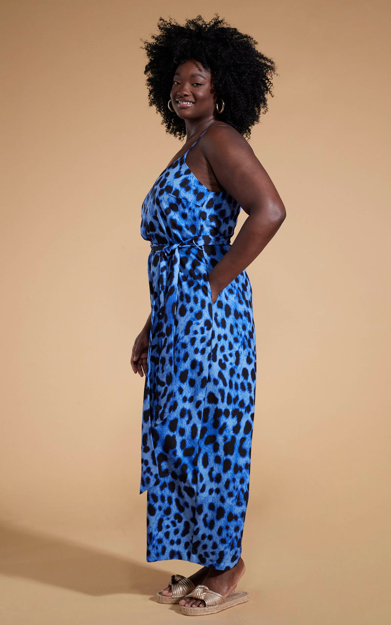 Dancing Leopard model wearing Gabriella Jumpsuit in Bright Blue Leopard facing side on