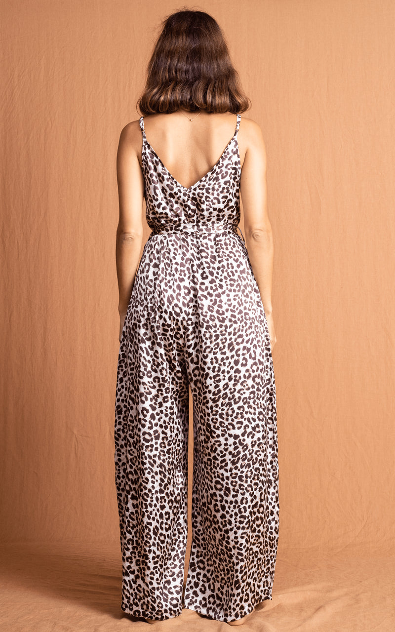 Dancing Leopard model faces backwards wearing Gabriella Jumpsuit in Bare Leopard
