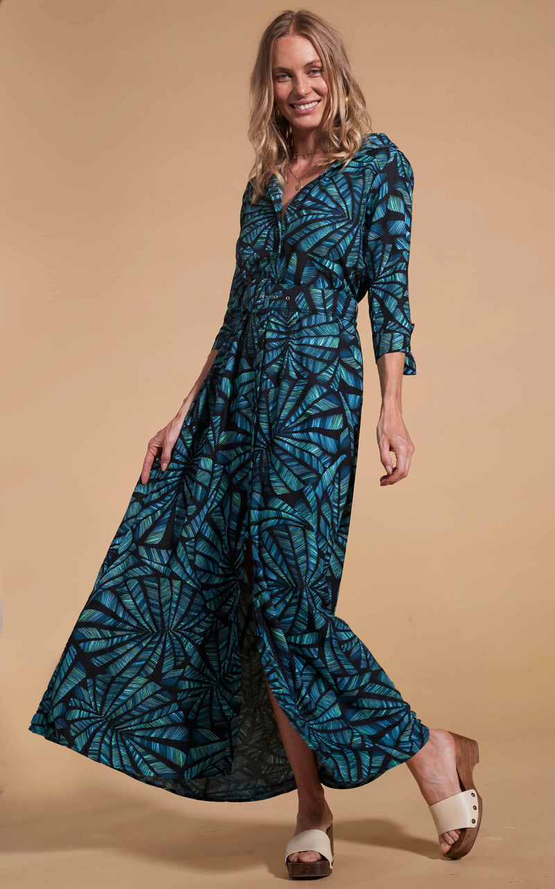 Dancing Leopard model wearing Dove Dress in Fan Turquoise on Black smiling and holding skirt out