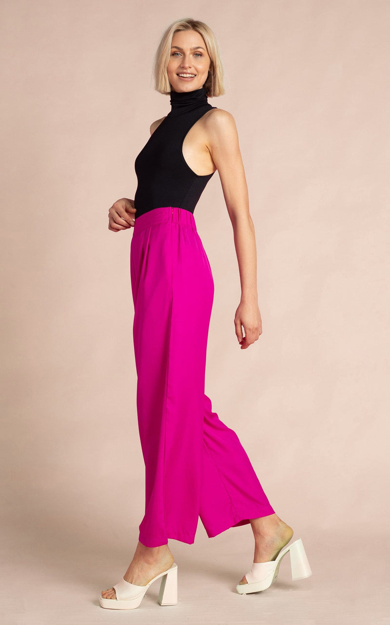Dancing Leopard model wearing Joey Palazzo Trousers in Magenta walking from right to left