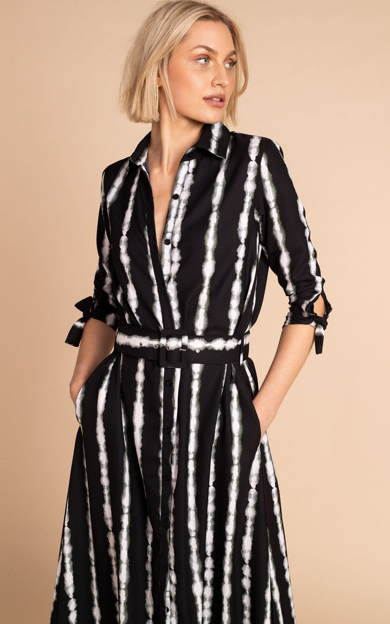 Close up of Dancing Leopard model standing with hands in pockets forwards wearing Dove dress in tie dye black and white stripe