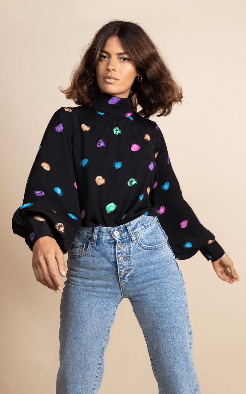 Dancing Leopard model faces forwards wearing Margo Blouse in Vintage Dots with jeans