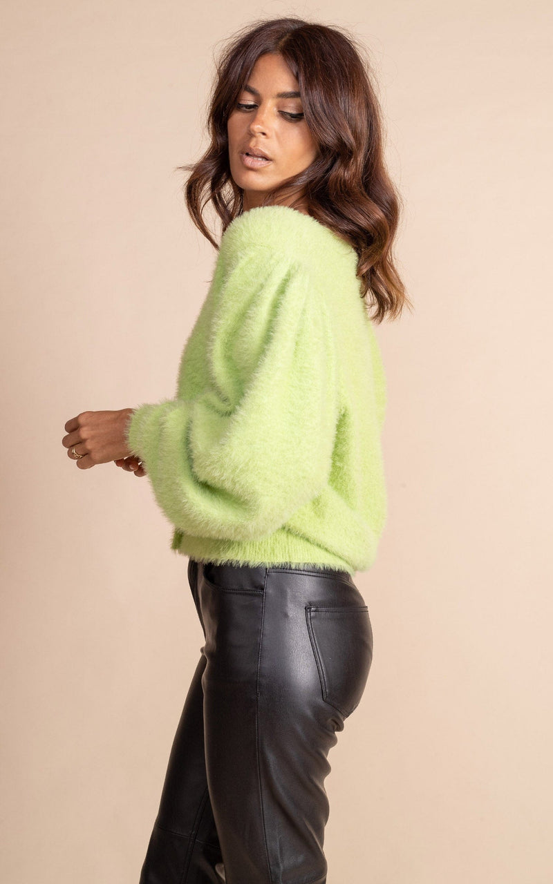 Dancing Leopard model wearing Bambino Cardigan in Sherbert posed looking over shoulder