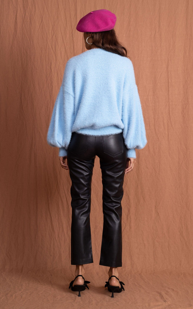 Dancing Leopard model wearing Honey Jumper in Baby Blue posed facing away to reveal back of jumper