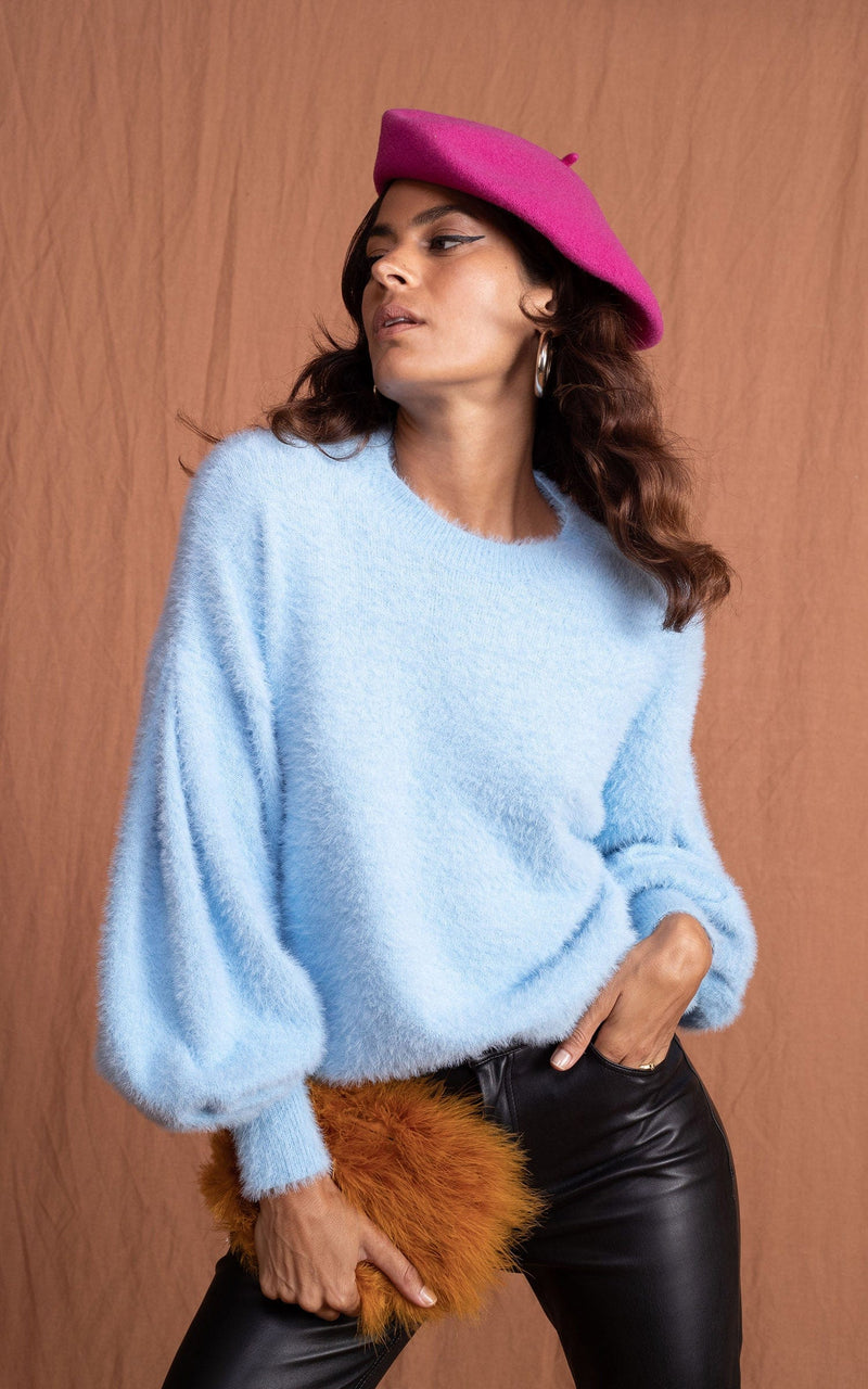 Dancing Leopard model wearing Honey Jumper in Baby Blue and pink beret posed with hand in pocket looking to the right