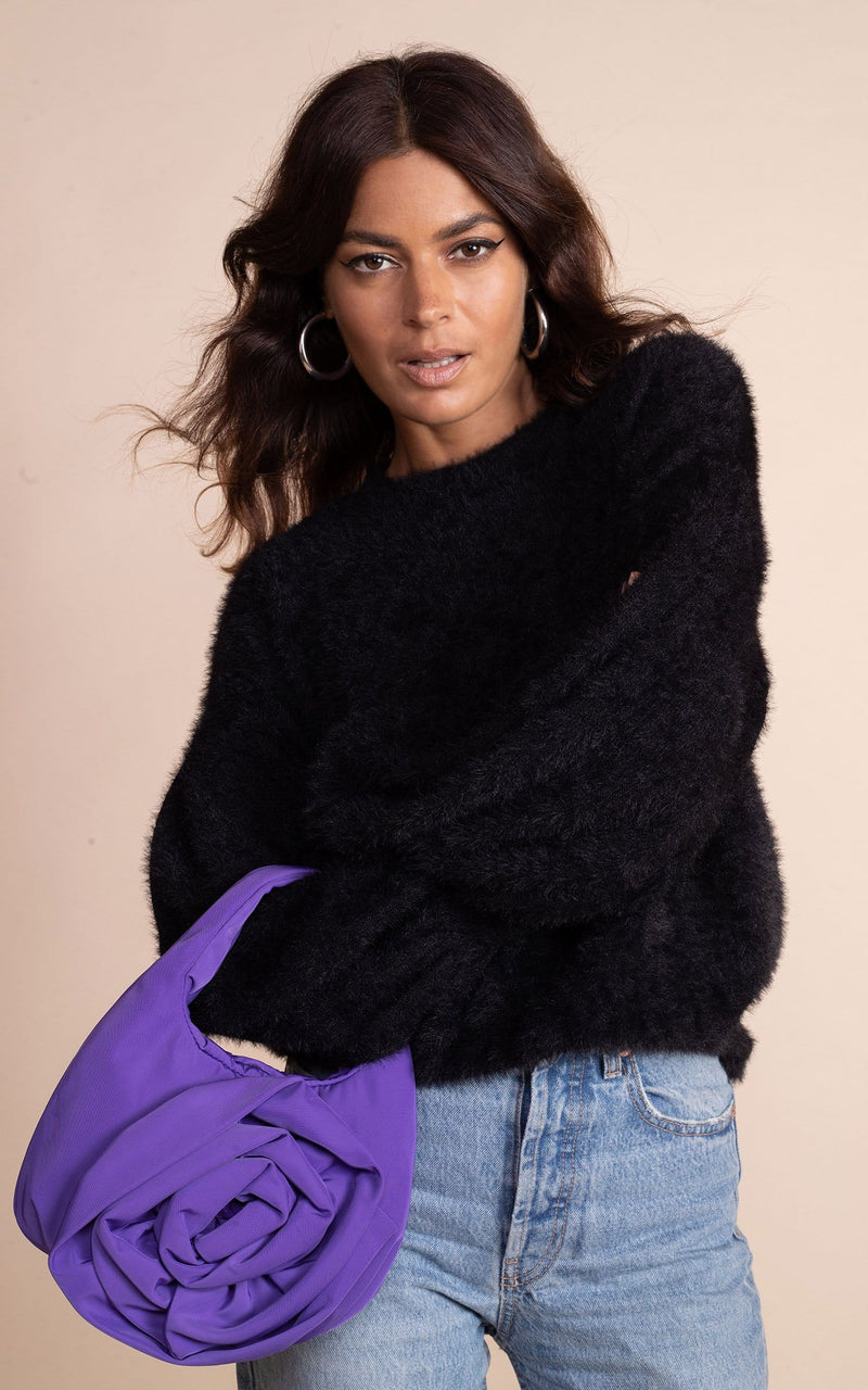 Dancing Leopard model wearing black fluffy honey jumper with blue jeans and purple bag