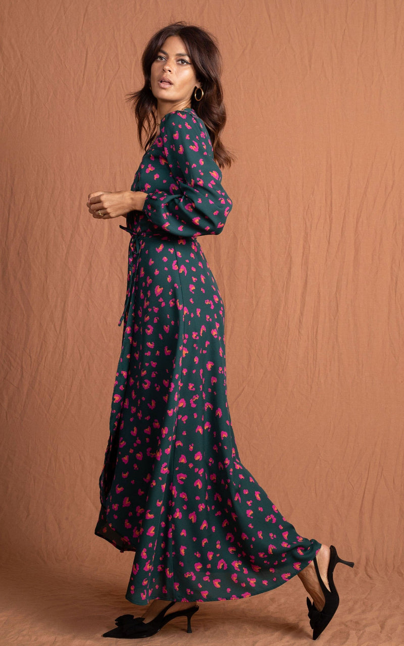 Dancing Leopard model standing sideways wearing jagger maxi dress in abstract pink on green