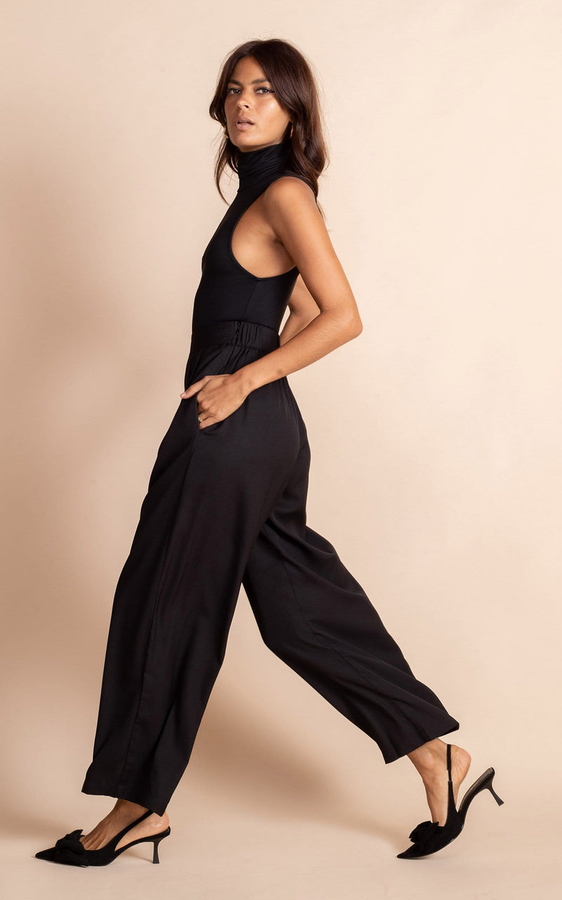 Dancing Leopard model wearing Joey Palazzo Trousers in Black walking from right to left