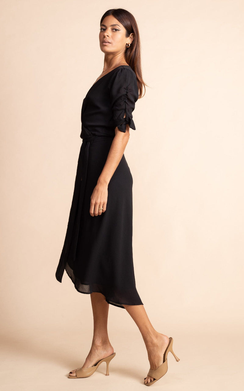 Dancing Leopard model faces sideways with wearing Olivera Dress in black