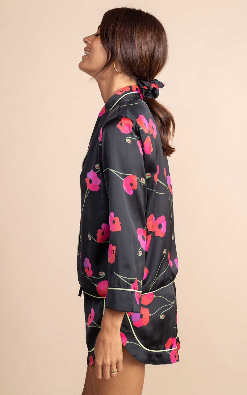 Dancing Leopard model standing to the side in Oona Pj set with shorts in black poppies