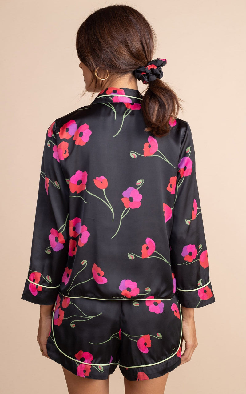 Dancing Leopard model standing with her back facing the camera in oona Pj set with shorts in black poppies