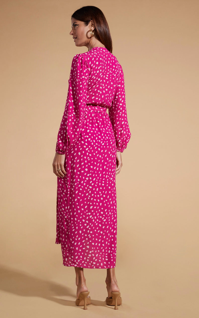 Dancing Leopard model wearing Mabel Midaxi Mock Wrap Dress in Odd Dot Pink on Magenta facing away to show back of dress