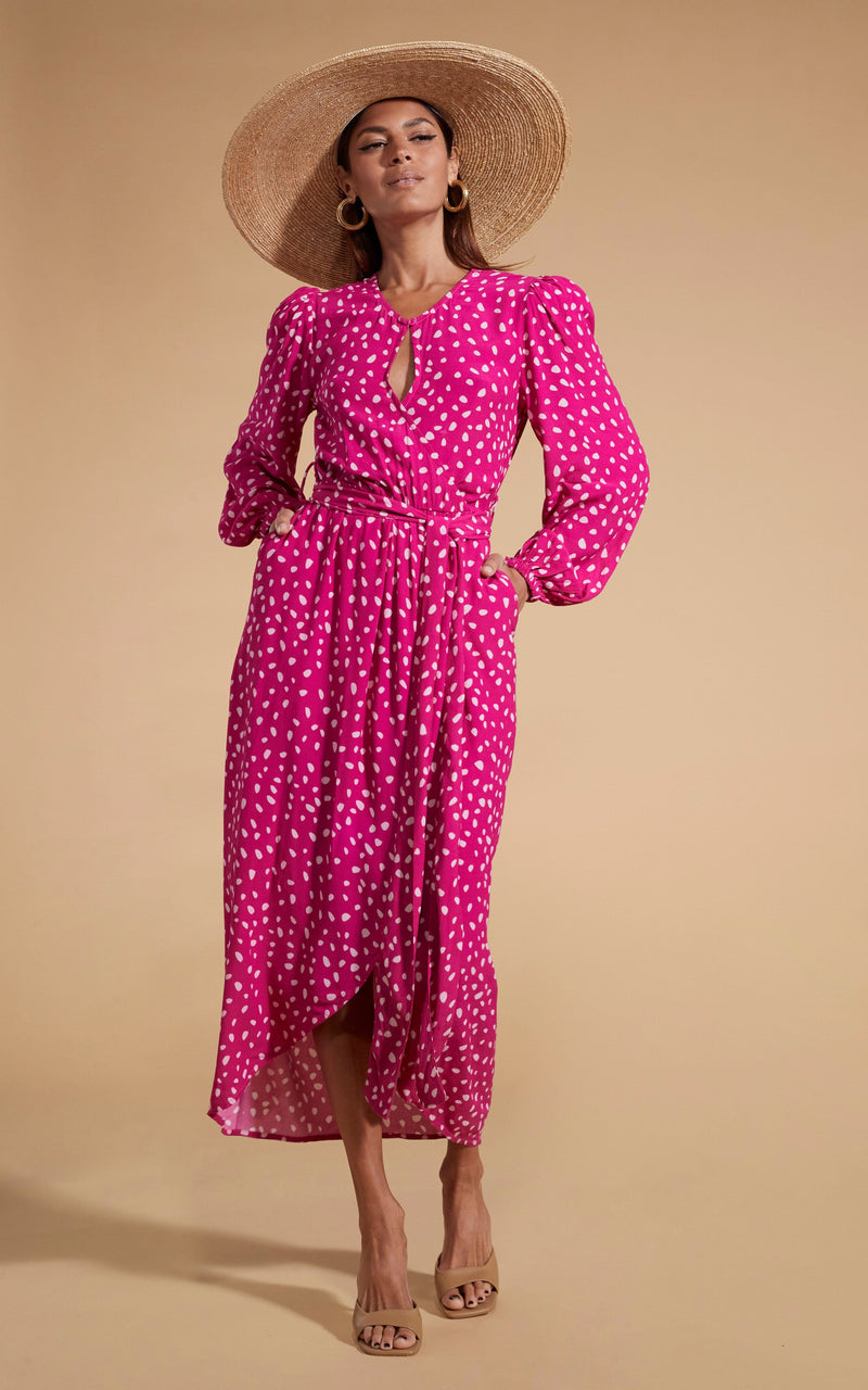 Dancing Leopard model wearing Mabel Midaxi Mock Wrap Dress in Odd Dot Pink on Magenta posed with hands in pockets