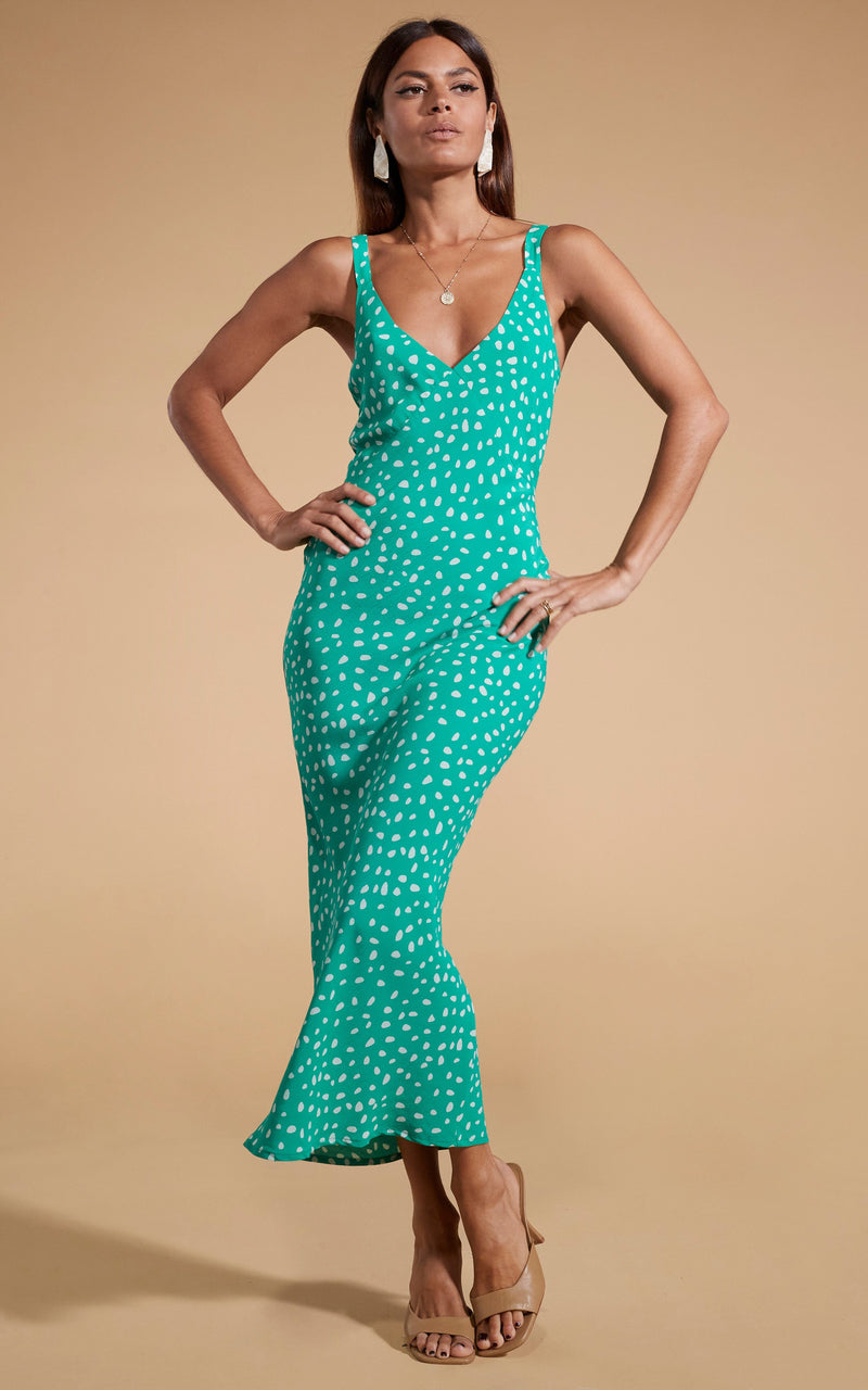 Dancing Leopard model wearing Sabrina Midaxi Dress in Odd Dot White on Sea Green posed with hands on hips