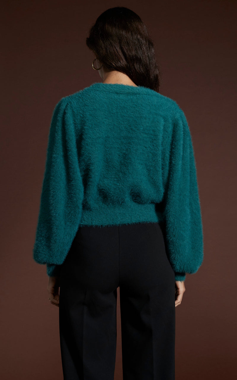 Dancing Leopard model wearing Ariana Cropped Cardigan in Forest Green facing away to reveal back details