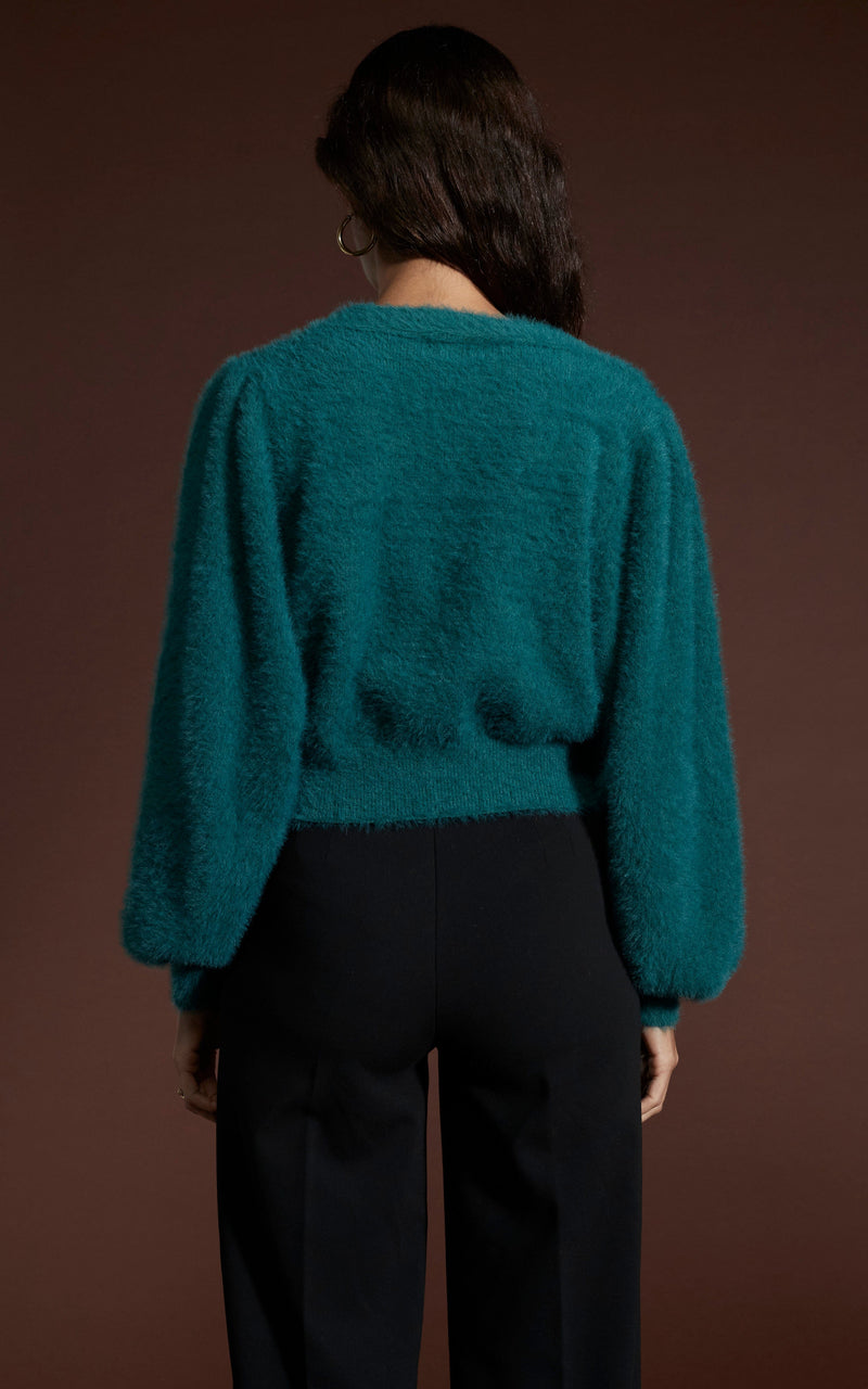 Dancing Leopard model wearing Ariana Cropped Cardigan in Forest Green facing away to reveal back details