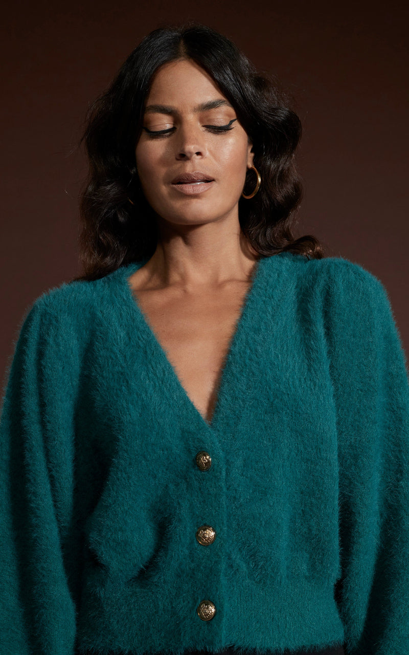 Dancing Leopard model wearing Ariana Cropped Cardigan in Forest Green posed looking down