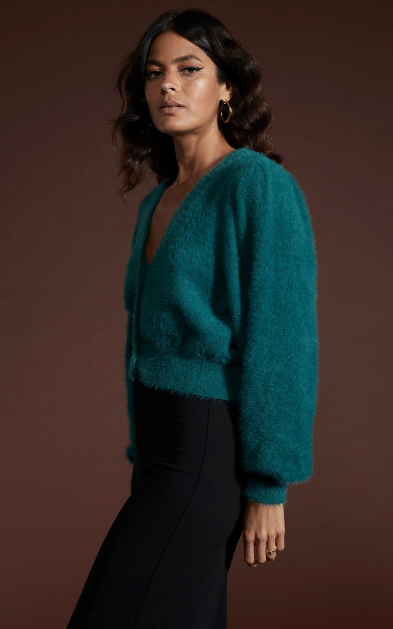 Dancing Leopard model wearing Ariana Cropped Cardigan in Forest Green walking from right to left