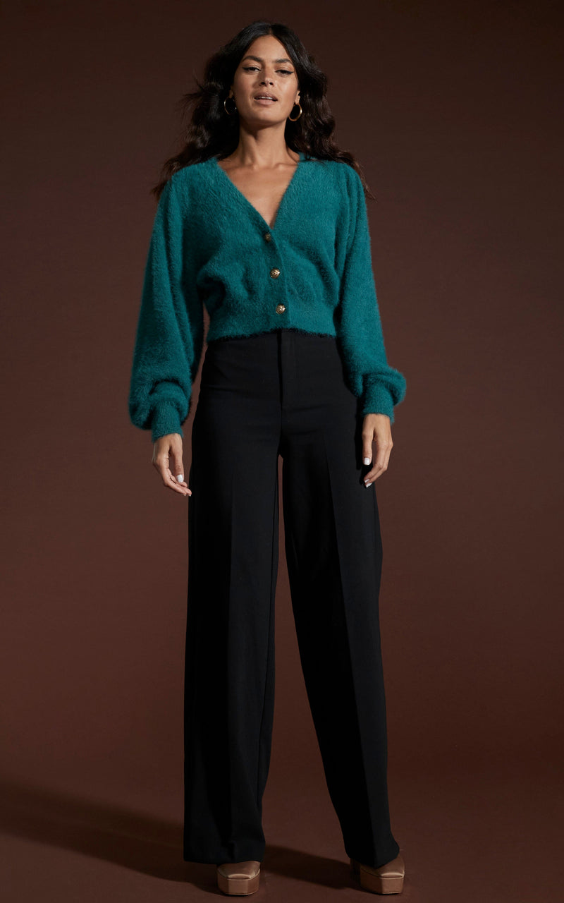 Dancing Leopard model wearing Ariana Cropped Cardigan in Forest Green and black trousers