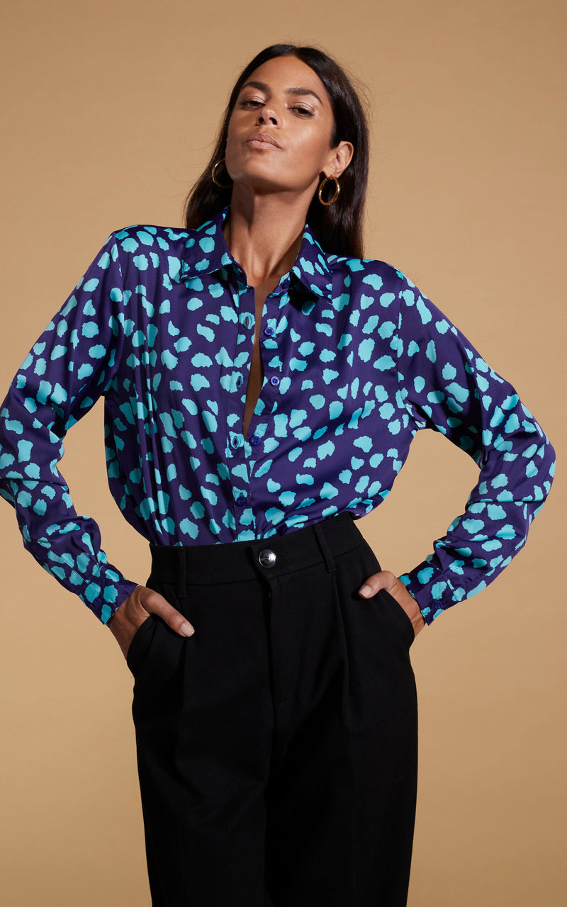 Dancing Leopard model wearing Nevada Satin Shirt In Ice Blue On Navy Cloud posed with hands in trouser pockets