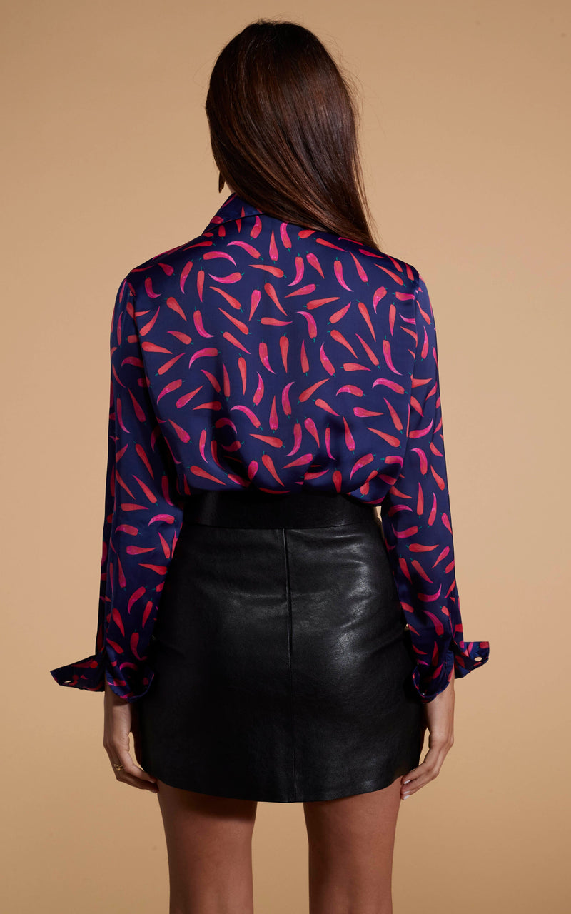 Dancing Leopard model wearing Nevada Satin Shirt In Chilli Pepper with leather look skirt facing away to show back of shirt