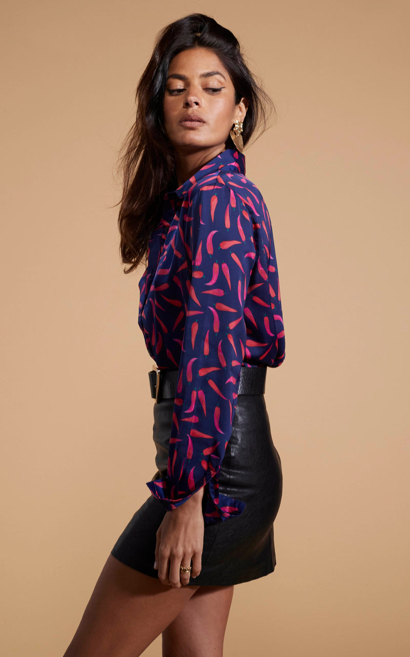 Dancing Leopard model wearing Nevada Satin Shirt In Chilli Pepper with leather look skirt facing side on