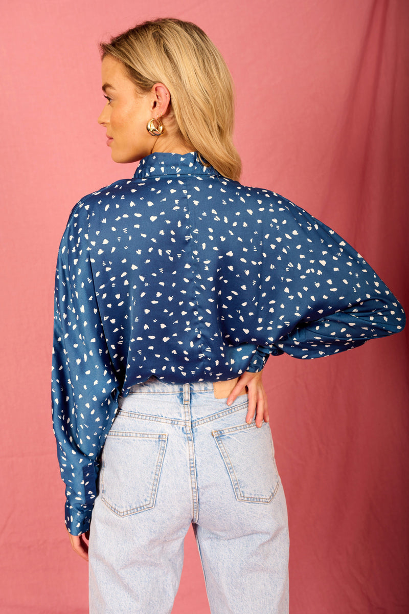 Dancing Leopard model wearing Satin Keaton Shirt in Abstract White on Navy facing away to show back of shirt
