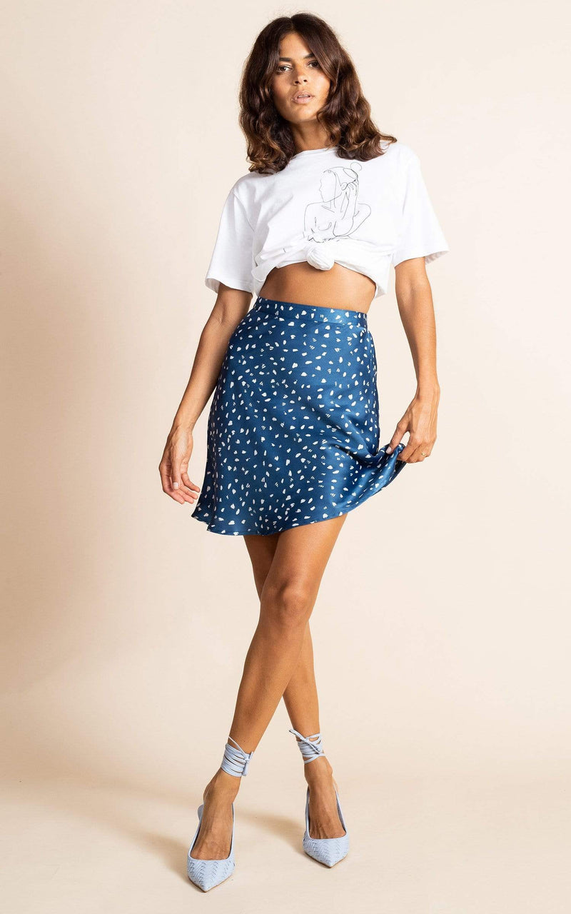 Dancing Leopard model faces forward wearing Stevie Mini Skirt in Abstract White on Navy with t-shirt and heels