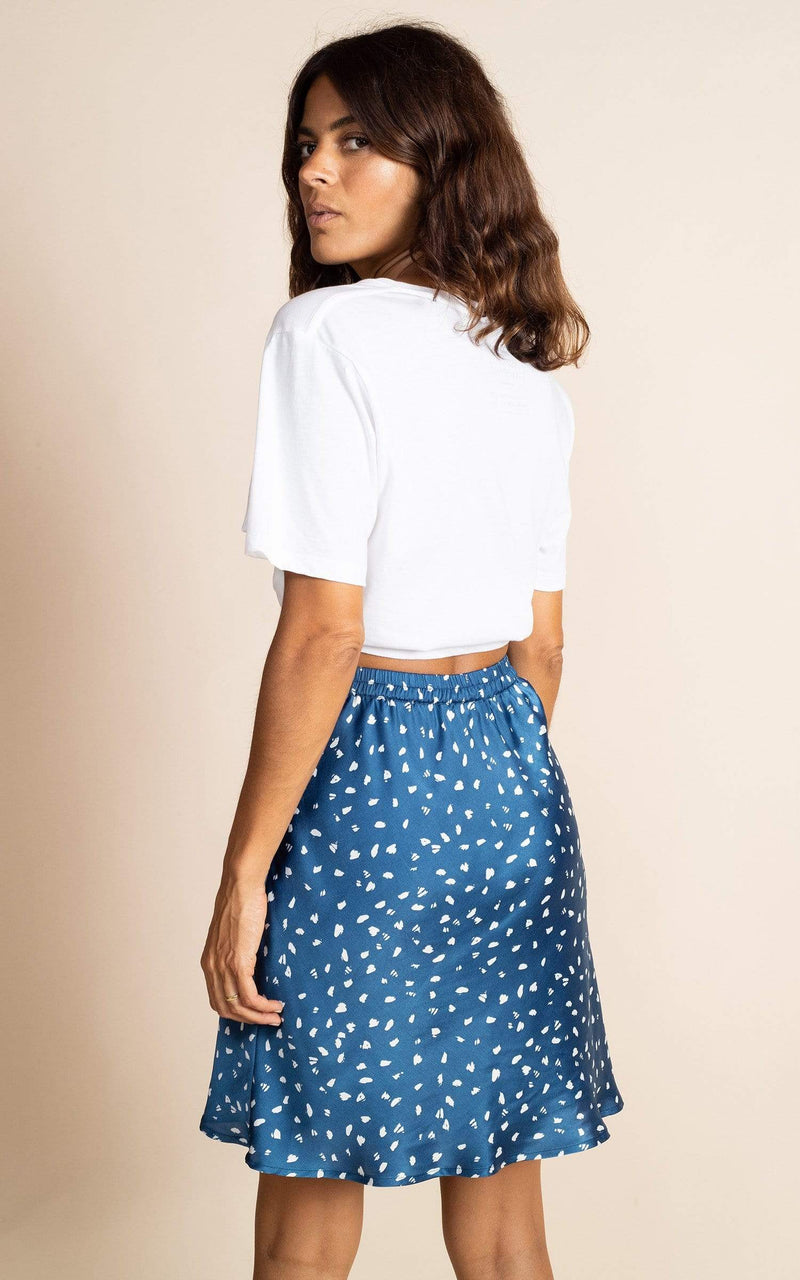 Dancing Leopard model faces side-on wearing Stevie Mini Skirt in Abstract White on Navy with t-shirt 
