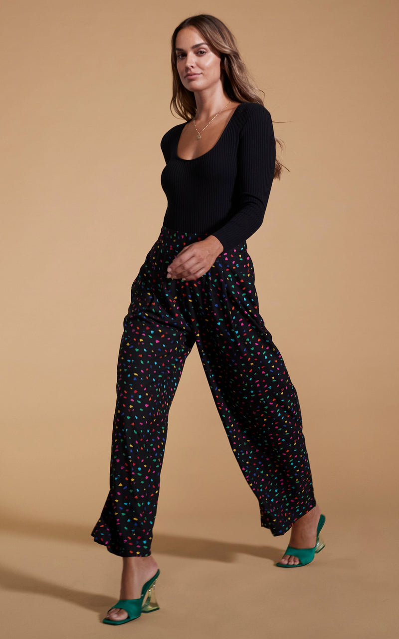Dancing Leopard model wearing Joey Palazzo Trousers in Abstract Multi walking from right to left