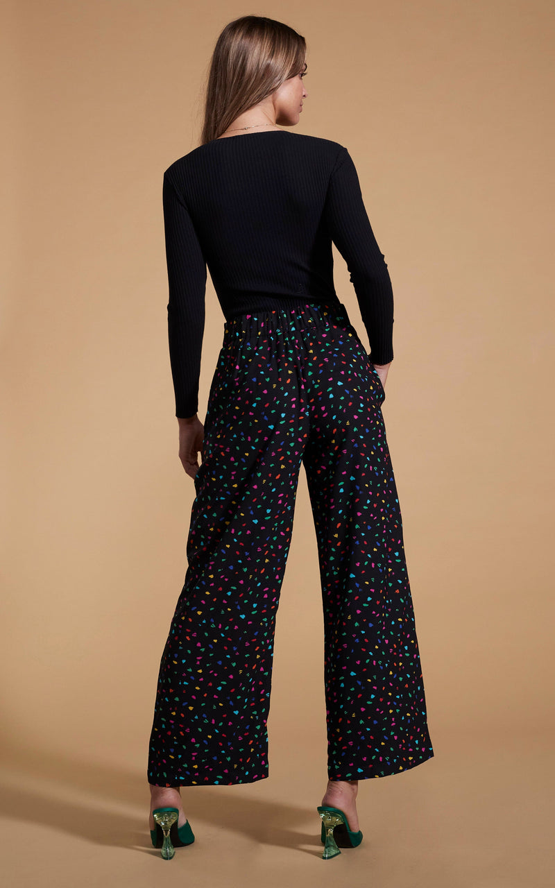 Dancing Leopard model wearing Joey Palazzo Trousers in Abstract Multi facing away to show back of trousers