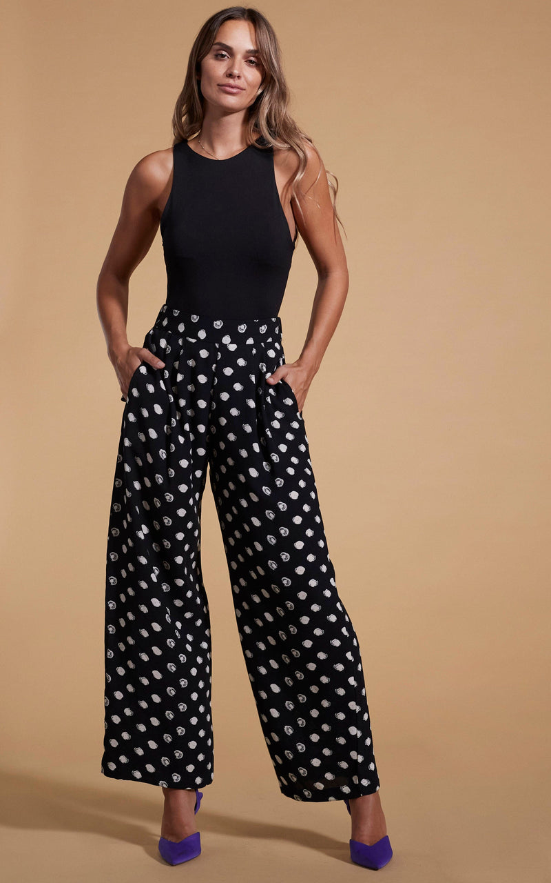 Dancing Leopard model wearing Joey Palazzo Trousers in Painted Dot posed with hands in pockets