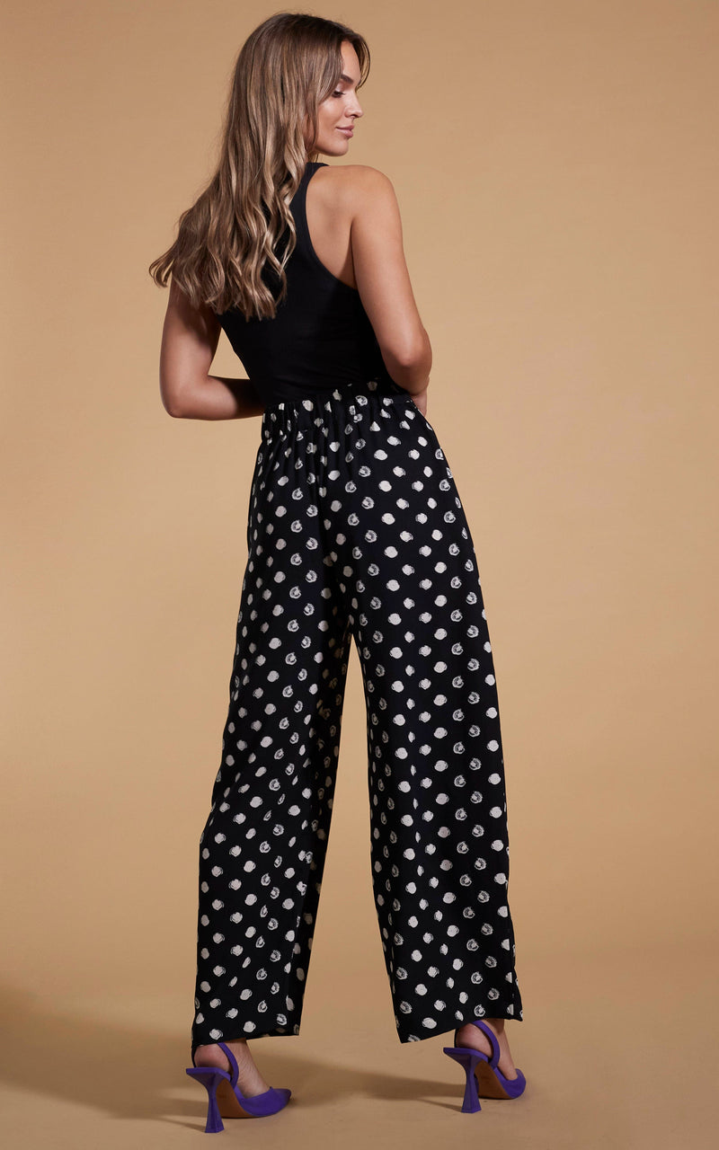 Dancing Leopard model wearing Joey Palazzo Trousers in Painted Dot facing away to show back of trousers