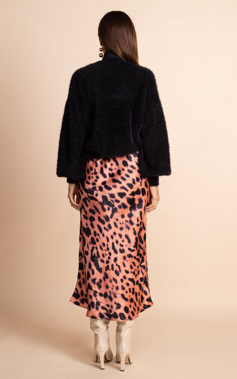 Dancing Leopard model wearing Renzo Skirt In Plorange Leopard facing away to show back of skirt