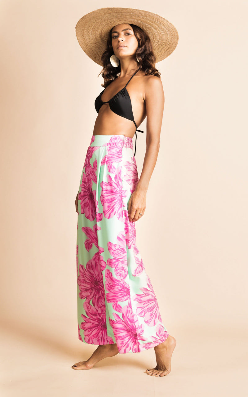 Dancing Leopard model wearing Joey Palazzo Trousers in Pink on Mint Bloom with black bikini top and straw hat