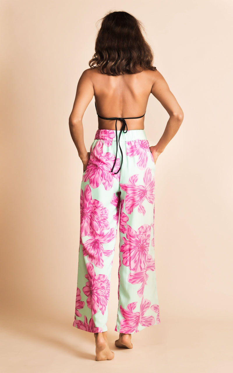 Dancing Leopard model wearing Joey Palazzo Trousers in Pink on Mint Bloom facing away to show back of trousers
